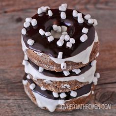 a stack of cookies with chocolate frosting and marshmallows