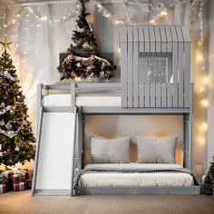 a bunk bed with a slide next to a christmas tree