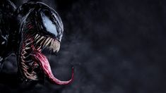 a close up of a very large alien with sharp teeth