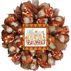 a wreath with pumpkins and words on it