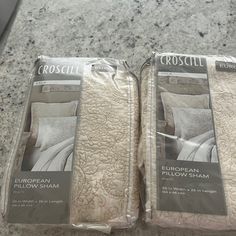 two sets of pillows in packaging on a table