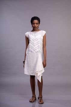 A loose summer shift dress, in a soft muted ivory color, with an interesting zig-zag patchwork detailing. This dress features a round neck and short cap sleeves. With a distinctive handkerchief design at the hem, this collection is created by patching up remnant pieces of fabric together. It is an extension of the Reduce-Reuse-Recycle philosophy. This dress can also be used as  a formal beach dress; a party or a wedding. Handloom cotton an Indian textile has been used in making this dress, hands Summer Linen Dress With Patchwork, Summer Linen Patchwork Dress, White Patchwork Knee-length Dress, White Knee-length Patchwork Dress, Chic White Patchwork Midi Dress, Formal Beach Dress, Magyar Sleeve, Handkerchief Design, Off White Dress