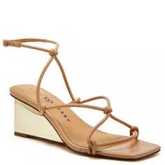 The Irisia Strappy By Katy Perry Has Slender Straps Adorning The Upper Of A Mid-Wedge Sandal. The Perfect Wedge Sandal To Pair With Your Favorite Summer Attire Whether You Are Dressing For A Casual Or Dressy Look. Heel Height- 2.36", Wedge Heel Buckle Closure Shoe Width- Medium Upper, Lining, Outsole- Manmade Square Toe Manmade Spot Clean Imported Never Worn Elegant Adjustable Wedge Sandals For Spring, Gold Wedge Sandals With Heel Strap For Spring, Gold Sandals With Padded Heel For Spring, Elegant Strappy Wedge Sandals For Summer, Elegant Spring Wedge Sandals With Ankle Strap, Spring Formal Wedge Sandals With Wrapped Heel, Formal Spring Wedge Sandals With Wrapped Heel, Evening Wedge Sandals With Padded Heel For Spring, Strappy Wedge Sandals For Spring Parties