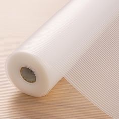 a roll of white paper sitting on top of a wooden table