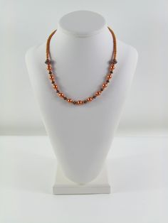 This necklace is made with two different sizes of copper colored glass pearls and copper accents. The necklace measures 19 inches. Elegant Copper Necklaces With Round Beads, Handmade Red Copper Necklace, Elegant Brown Copper Necklace, Luxury One-of-a-kind Copper Necklace, Handmade Rust-colored Copper Necklaces, Copper Pearl, Copper Accents, Copper Color, Colored Glass