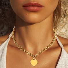 The Designer Inspired White Gold Dipped Brass Metal Heart Lock Pendant Necklace is a chic and timeless piece, featuring a heart pendant symbolizing love and protection. Available in both white gold and gold, this necklace offers versatile styling options. The pendant, measuring 0.75" X 1", hangs gracefully from an 18" chain, creating a classic silhouette. Crafted from brass and dipped in gold for a luxurious finish, this necklace is both durable and elegant. Lead and nickel compliant, it is safe Trendy Gold Plated Heart Necklace With Clavicle Chain, Trendy Gold Heart Necklace, Valentine's Day Heart Necklaces With Gold Chain, Valentine's Day Heart Necklace With Gold Chain, Valentine's Day Gold Chain Heart Necklace, Valentine's Day Heart Shaped Gold Chain Necklace, Gold Heart Pendant Necklace Trendy, Trendy Gold Heart Pendant Necklace, Trendy Gold Plated Heart Necklace With Heart Charm