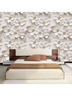 a bedroom with white flowers on the wall