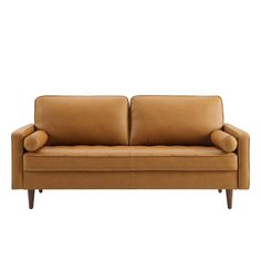 a tan leather couch with wooden legs and armrests on an isolated white background