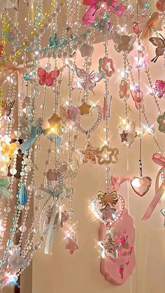 a room filled with lots of different types of necklaces hanging from the ceiling next to each other