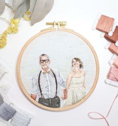 an embroidery project with a man and woman holding hands