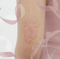 a woman's arm with a tattoo on it that has a dragonfly drawn on it