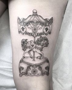 a black and white photo of a carousel tattoo