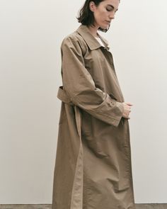 Oversized fit tench with mid-weight cotton blend fabric, spread collar, detachable belt, and welt pockets. *All sale items are final sale* Shell: 60% Cotton, 40% nylon Lining: 100% Polyester Dry clean Classic Belted Outerwear For Daywear, Classic Khaki Outerwear With Belted Cuffs, Classic Khaki Belted Outerwear, Classic Oversized Outerwear With Belted Cuffs, Classic Outerwear With Belted Cuffs For Daywear, Belted Cotton Outerwear For Work, Spring Cotton Outerwear With Belted Cuffs, Cotton Belted Outerwear With Lapel Collar, Cotton Outerwear With Belted Cuffs For Work