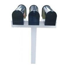 three black mailboxes sitting on top of a white pole in front of a white wall