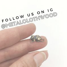 a person holding a tiny animal ring in their hand with the words follow us on it