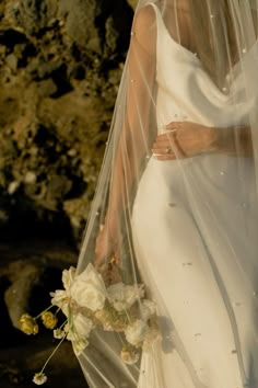 a woman in a white wedding dress and veil