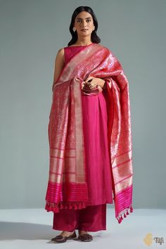 "Resplendent silk and master craftsmanship from Banaras, because we know you expect nothing short of the best!\u00a0This rich and luxurious Shikaargah dupatta is certain\u00a0to make a statement. Be ready to make heads turn with this ode to old, royal hunting traditions.\n\u00a0\n\n\n Color\u00a0- A\u00a0beautiful shot colour of Red and Rani Pink\n\n Technique\u00a0- Classic handwoven Banarasi art passed down through generations of weavers.\n\n Fabric\u00a0- Soft as butter, pure Katan silk\n\n Speciality\u00a0-\u00a0With a melange of motifs of birds, animals, flora and fauna, Shikaargah is a testament to the skill of our weavers and the wonders\u00a0they are capable of. This is woven art and a Banarasi\u00a0masterpiece.\n\n Tilfi Promise\u00a0- Pure. Handloom. Banaras.\n\n\u00a0\n\nSince t Suit Designs Indian Style Latest Cotton, Silk Suit Designs Indian, Suit Designs Indian Style Latest, Pink Suits Women, Suit Designs Indian Style, Indian Suits For Women, Expect Nothing, Rani Pink, Dresses By Pattern