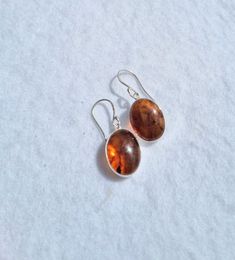 Simple amber drops dangle earrings with sterling silver.  Beautiful orange color. Good for gift for womens. Size of the stone 15mm L x 12mm w Amber Drop Earrings, Polished Drop Earrings For Gift, Polished Finish Drop Earrings For Gift, Classic Orange Jewelry As Gift, Classic Orange Jewelry For Gift, Polished Sterling Silver Earrings As A Gift, Orange Oval Sterling Silver Jewelry, Orange Polished Finish Jewelry For Gift, Silver Baltic Amber Earrings