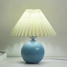 a blue lamp sitting on top of a white table