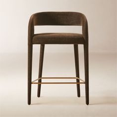 an upholstered bar stool with a wooden frame and backrest in brown fabric