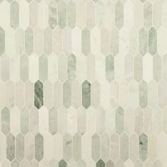 a white and green tiled wall with hexagonal tiles