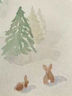 two rabbits are sitting in the snow next to a pine tree, and one bunny is laying down