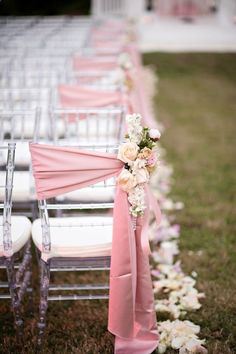 rows of chairs with pink sashes and white flowers