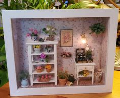 a doll house with flowers and plants in it