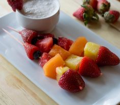 strawberries and other fruit on a white plate