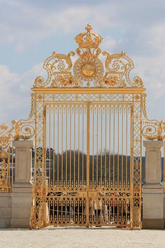 an ornate gold gate with people in it