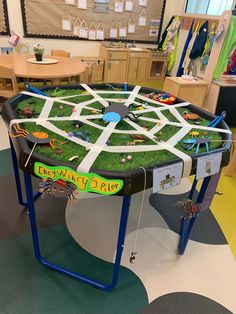 a play table with toys on it in a room filled with children's furniture