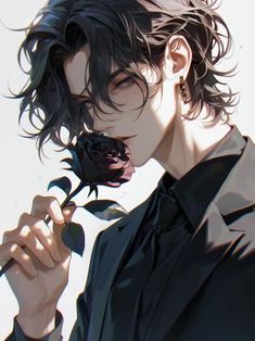 a man holding a rose in his right hand and wearing a black shirt with long sleeves