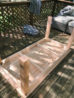 a wooden boat sitting on top of a wooden deck next to a person standing in the background