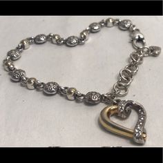 Heart Shaped Charm With Rhinestones Makes This Silver And Gold Tone Bracelet Rare. Has Extender For Bigger Wrists. Perfect Accessory For Any Occasion. New Without Tags. Silver Heart Bracelet With Diamond Accents, Elegant Silver Heart Bracelet, Silver Heart Bracelets With Diamond Accents, Heart-shaped Silver Bracelets With Diamond Accents, Elegant Silver Heart Charm Bracelet, Heart Shaped Silver Bracelets With Diamond Accents, Elegant Silver Heart Bracelet With Diamond Accents, Silver Open Heart Bracelet For Anniversary, Elegant Silver Charm Bracelet With Heart Beads