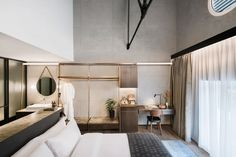 a bedroom with a bed, desk and mirror