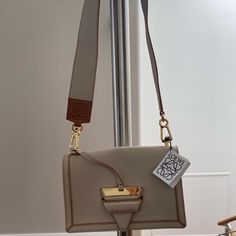 Loewe Barcelona Leather Shoulder Bag ; 9.5”X6.5”X3.5”, One Back Slip Pocket, 3 Compartments Interior, Removable Shoulder/ Crossbody Strap Drop 19”( 2”Width). New W/ Tag, Dust Bag. Retail $2695 High-end Cream Shoulder Bag, Luxury Cream Rectangular Shoulder Bag, Designer Rectangular Cream Shoulder Bag, Designer Cream Rectangular Shoulder Bag, Designer Cream Shoulder Bag, High-end Cream Shoulder Bag With Detachable Strap, Designer Square Shoulder Bag For Everyday Luxury, Designer Cream Square Shoulder Bag, Luxury Cream Square Bag