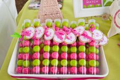 a tray filled with candy covered in pink and green candies