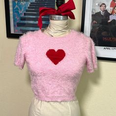 Brand New, Never Worn. Super Soft Fuzzy Pink Cropped Sweater With Red Heart On Chest. Short Sleeve With Round Neckline. Pink Heart-shaped Top For Valentine's Day, Pink Heart Print Tops For Valentine's Day, Fitted Winter Top With Heart Print, Pink Fitted Tops For Valentine's Day, Pink Fitted Top For Valentine's Day, Heart-shaped Pink Top For Valentine's Day, Pink Short Sleeve Winter Tops, Pink Short Sleeve Tops For Winter, Fitted Heart Print Top For Valentine's Day