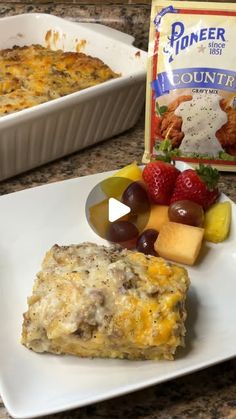 a white plate topped with food next to a container of yogurt and fruit