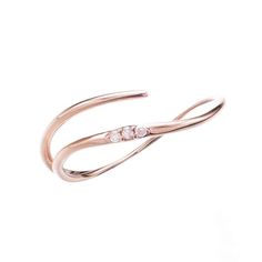 a rose gold ring with two diamonds on it's sides, set against a white background