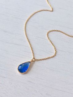 Blue Quartz Teardrop Necklace, Royal Blue Necklace, Small Sapphire Pendant, Dainty Minimal Gold Necklace, Gift for her, September Birthstone This simple dainty necklace features an deep royal blue quartz teardrop set in texturized bezel in your choice of gold filled or sterling silver. This framed stone pendant is suspended from a delicate cable chain in the finish of your choice. This necklace is simply perfect for everyday wear and is perfect for layering with other pieces in your collection. Elegant Blue Crystal Necklaces With Adjustable Chain, Elegant Blue Crystal Necklace With Adjustable Chain, Elegant Blue Teardrop Drop Necklace, Elegant Blue Crystal Necklace With Clavicle Chain, Elegant Blue Teardrop Crystal Necklace, Blue Teardrop Pendant Necklace With Adjustable Chain, Blue Teardrop Necklace With Adjustable Chain, Blue Gemstone Teardrop Pendant Necklace, Dainty Blue Teardrop Pendant Necklace