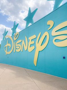 there is a sign that says disney's on the side of a building with stars