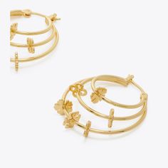 Delicate geometry. Graphic cutouts reinterpret the classic good luck charm on our Kira Clover Hoop Earring. For pierced ears. Luxury Gold Earrings With Flower Charm, Luxury Gold Earrings With Logo Charm, Luxury Gold-plated Flower Earrings For Pierced Ears, Tory Burch Set Jewelry, Tory Burch Hoop Earrings, Tory Burch Kira, Luck Charm, Luck Charms, Designer Jewelry