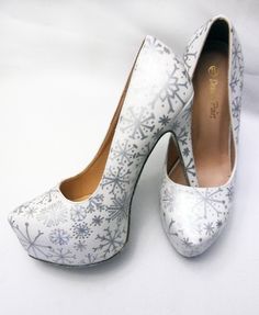 Let it snow, let it snow, let it snow!  If a winter wonderland is what you love most, the Silver Snowflake Heels are for you!  These heels are absolutely stunning!  Hand painted in Silver are unique and beautiful snowflakes.  Layered on top of these stunning snowflakes is a white iridescent glitter to make your shoes sparkle just like fresh fallen snow.  The soles of the heels are done in a silver glitter to accent the silver snowflakes.  Each pair is coated to be water proof, UV resistant and stain resistant.   If you're in need of a different heel height, that option is available to you!  If there is a size you need that isn't listed, or you'd like a totally different shoe style all together, please contact me for further assistance. Please allow 1 to 2 weeks for creation! SIZING:  Our s White Closed Toe Heels For Winter, White Glitter Party Heels, Christmas Heels, Painted Heels, Hand Painted Heels, December Mood, Heels Glitter, Christmas Sparkle, Heels Silver