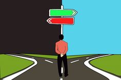 a man standing in the middle of a road with two signs pointing to different directions