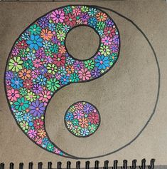 a drawing of a flowered yin - yang on a piece of paper with scissors