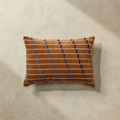 a brown pillow with blue lines on it