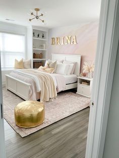 a bedroom with white furniture and pink walls