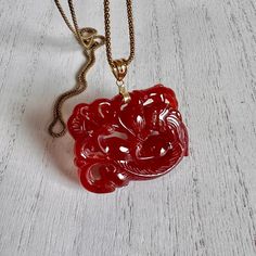 Sinuous Silhouette Of The Mythical Beast Is Rendered In Carved Red Jade. 14kt Gold. Pendant Is Approximately 1 3/4 Inch By 1 3/34 Inch With The Bail. The Jade Pendant Is A Little Darker Than The First Photo As You Can See By The Darker Photos. Woven Rope Chain Is Approximately 28 Inch And Is ..925 Italy Danecraft. Estate Piece. Great Condition. Includes Original Cloth Bag And Polish Cloth. Red Jade Necklace, Necklace Dragon, Jade Dragon, Red Jade, Mythical Beast, Dragon Necklace, Jade Necklace, Dragon Pendant, Cloth Bag