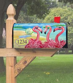 a mailbox with two flamingos painted on it